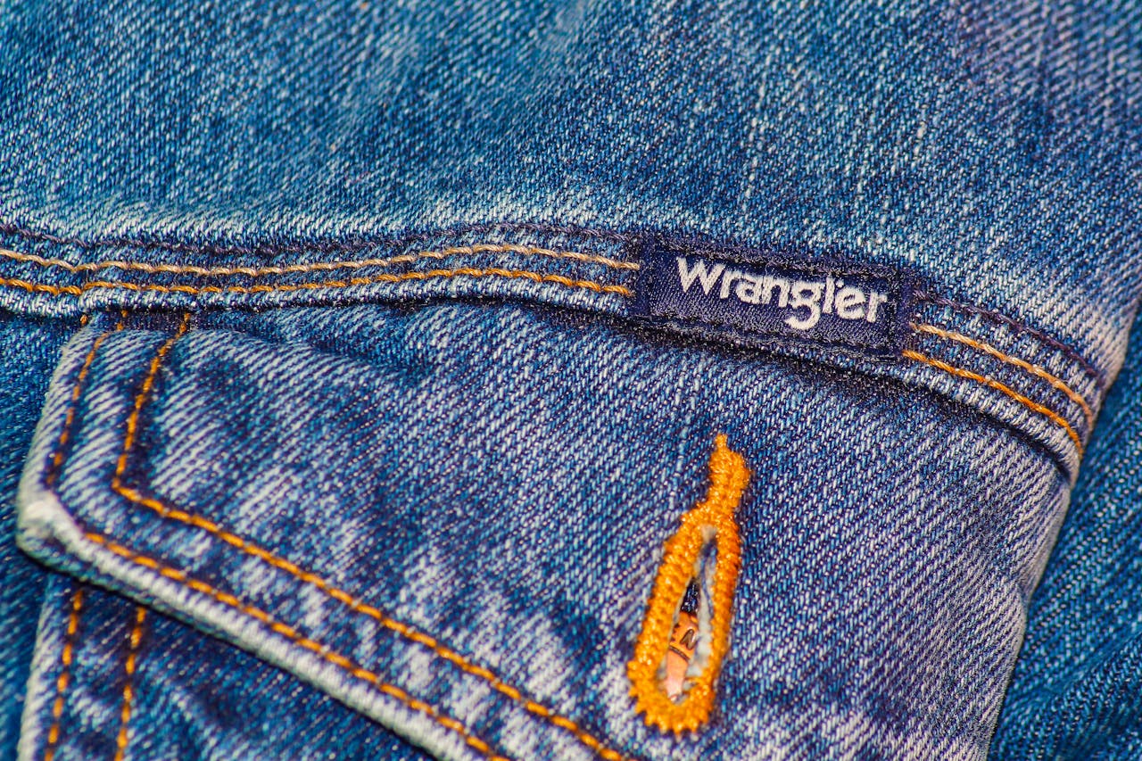 Detailed view of a Wrangler jeans pocket showcasing blue denim texture and stitching.